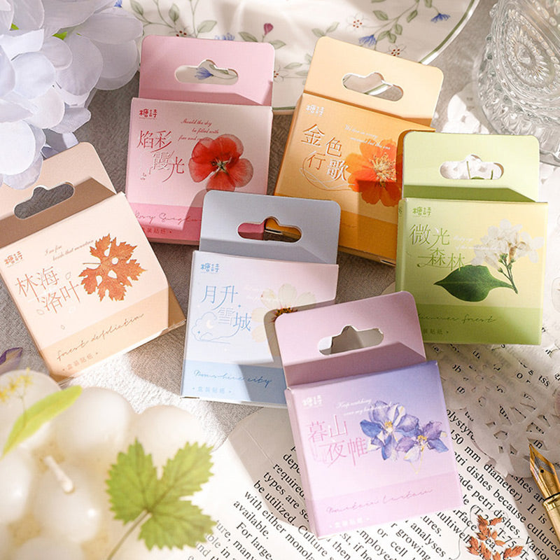 Six pastel sticker boxes on newsprint with a leaf sticker and a Flower Language series banner above them
