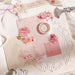 Pink flower stickers on a white lace doily with a pink box, plus a scrapbook page with rose stickers