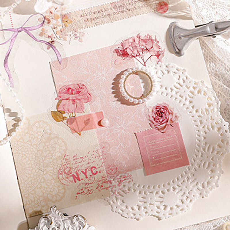 Pink flower stickers on a white lace doily with a pink box, plus a scrapbook page with rose stickers