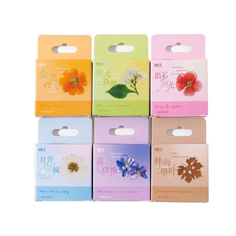 Six hang-tab sticker boxes in orange, green, pink, pale blue, lilac and tan lined up, one for each flower pattern