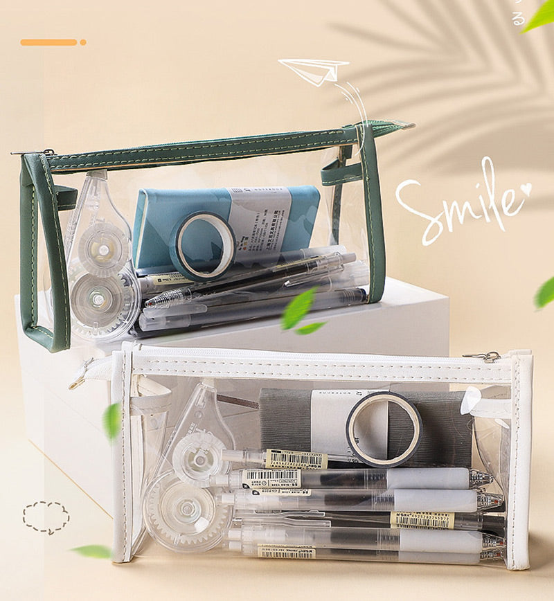 Green and white clear triangular zipper pencil cases stacked diagonally with stationery inside