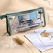 Clear triangular zipper pencil case with green trim showing 210×150×55mm size callouts