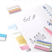 Four width options of KOKUYO Campus HALCO sticky notes laid beside a hand-drawn notebook page