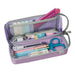 Open lilac purple tray pen case holding index tabs, a pink ruler, tape, an eraser, scissors, a cutter and pastel pens