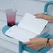 Open Paperideas 2027 August monthly calendar spread on a blue cafe table beside an iced fruit drink and pen