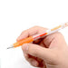 Hand holding an orange gel pen highlighting its smooth metal-tipped writing point