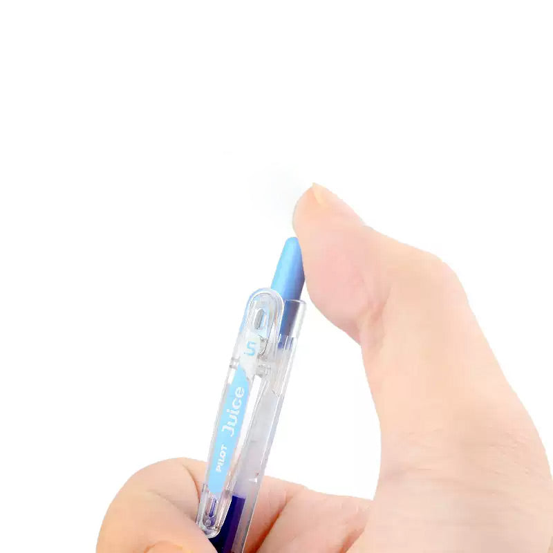 Close-up of a thumb pressing the click button on a gel pen barrel