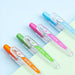 Close-up of the gel pen's wide-opening spring clip for notebook attachment