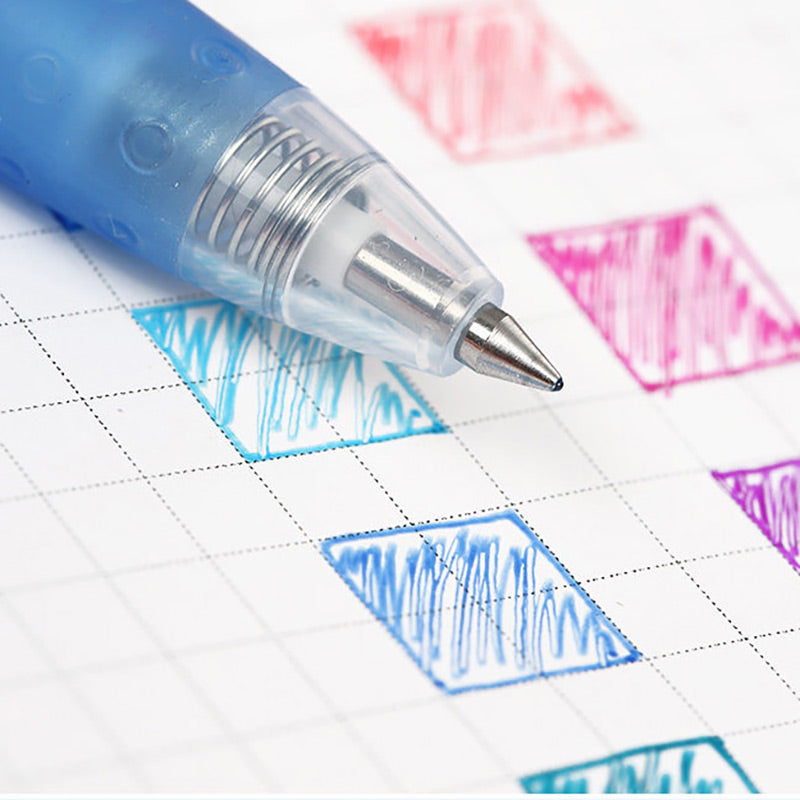 Macro shot of a gel pen nib drawing a blue swatch on grid paper