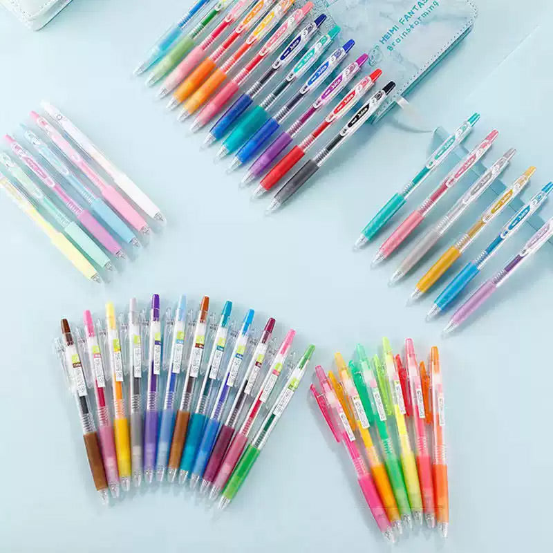 Gel pens on a blue background beside a writing sample swatch chart