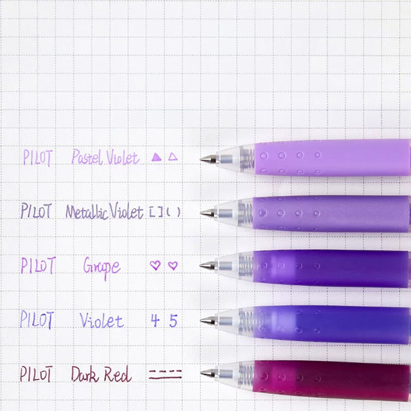 Pastel gel pens on a flat-lay desk scene with a notebook and plant
