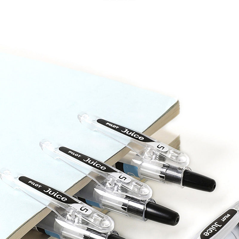 Three black PILOT Juice gel pens are shown on lined paper.