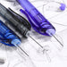 Purple, black and blue mechanical pencils with lead being fed in from the back end over a pencil sketch
