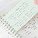 Green lined index card with handwritten vocabulary notes clipped over a ring-bound notebook