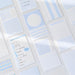 Overhead view of blue index cards in different layouts with a handwritten daily plan card and number stickers