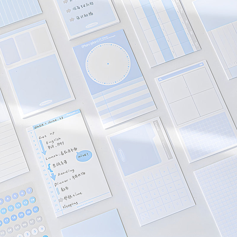Overhead view of blue index cards in different layouts with a handwritten daily plan card and number stickers