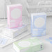 Pink, blue, green and mix index card boxes stacked and grouped on a desk with a notebook and stickers
