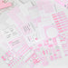 Pink index cards and sticker sheets laid flat, showing lined, grid, calendar and schedule layouts