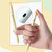 Hand clicking a yellow C-JJ20 pen with a close-up of the side window that turns black when the tip is out