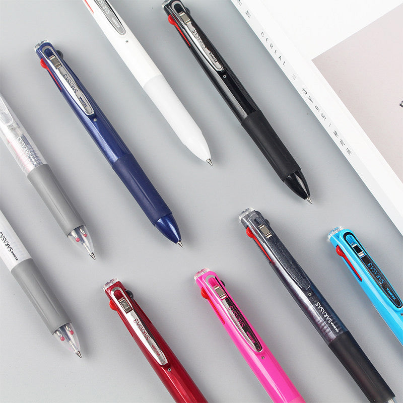 Overhead view of navy, white, black, red, pink and sky blue multi pens lying on a grey desk