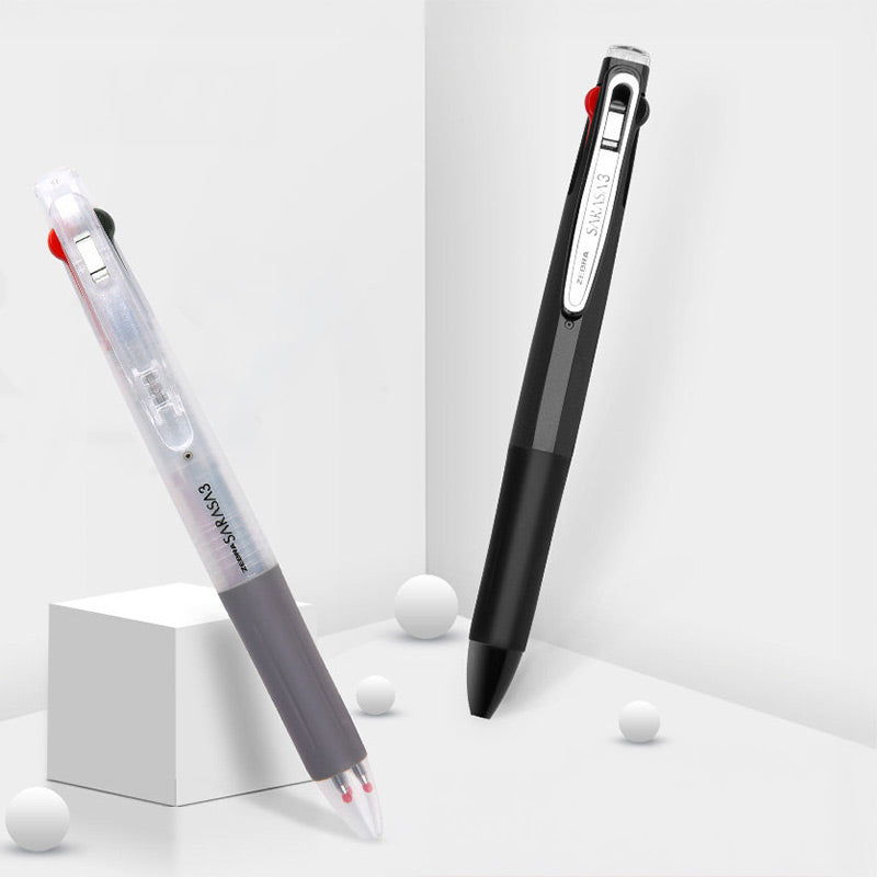 A clear-barrel multi pen and a black multi pen standing on white blocks in a bright studio set
