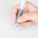 Hand holding a clear-barrel multi pen by its grey grooved grip to show a comfortable writing grip