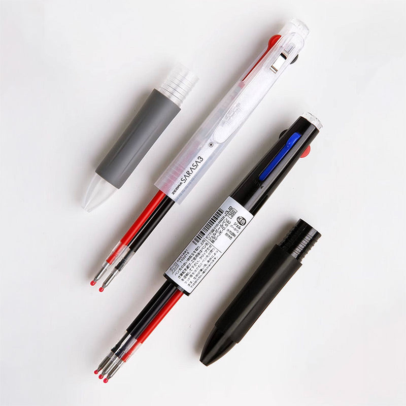 Hand holding a clear multi pen above an opened barrel showing three gel ink refills and a black cap