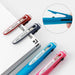 Red, navy, sky blue and pink multi pens resting on a notebook, with a close-up of the clip lifting open