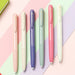 Six uni-ball Signo RT1 pens in pastel pink, cream, violet, sage green, coral pink and ivory on striped paper