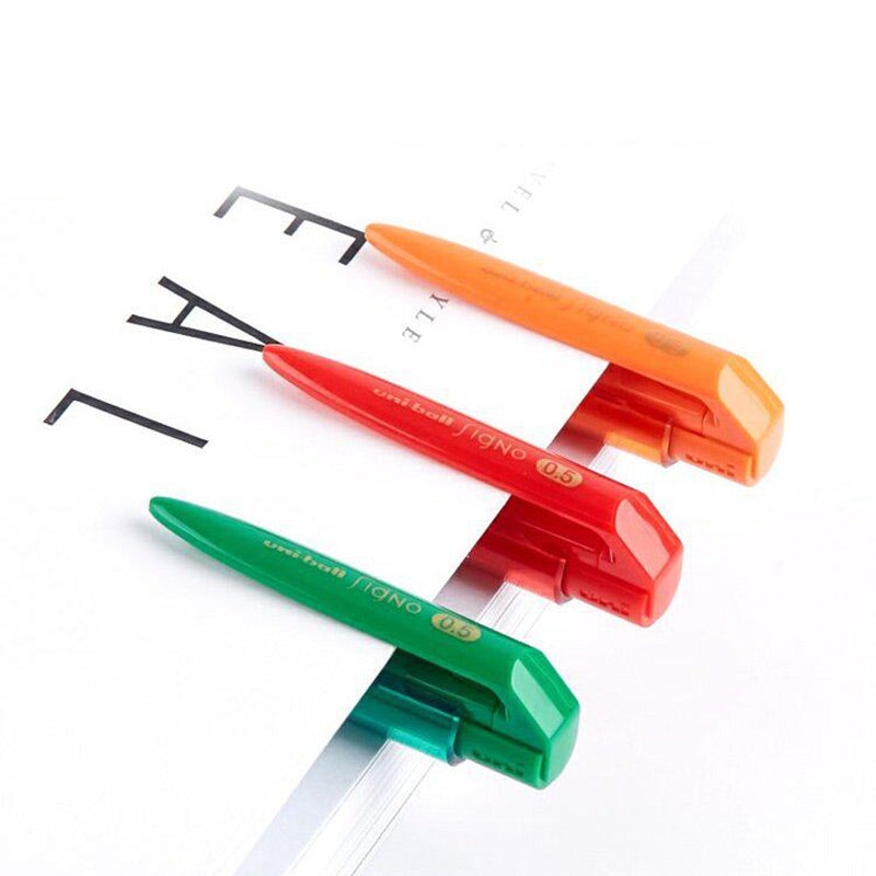 Orange, green, red, navy and blue transparent-barrel Signo RT1 pens on a spiral notebook with clip close-ups