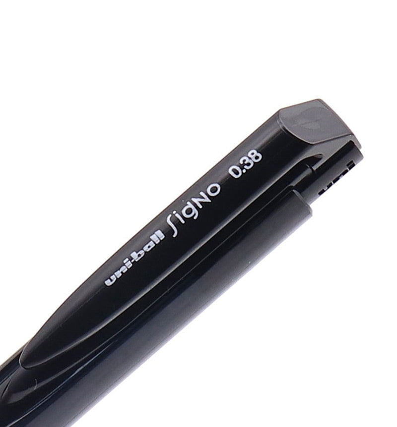 Close-up of the bevelled push button end of a black Signo RT1 0.38 pen