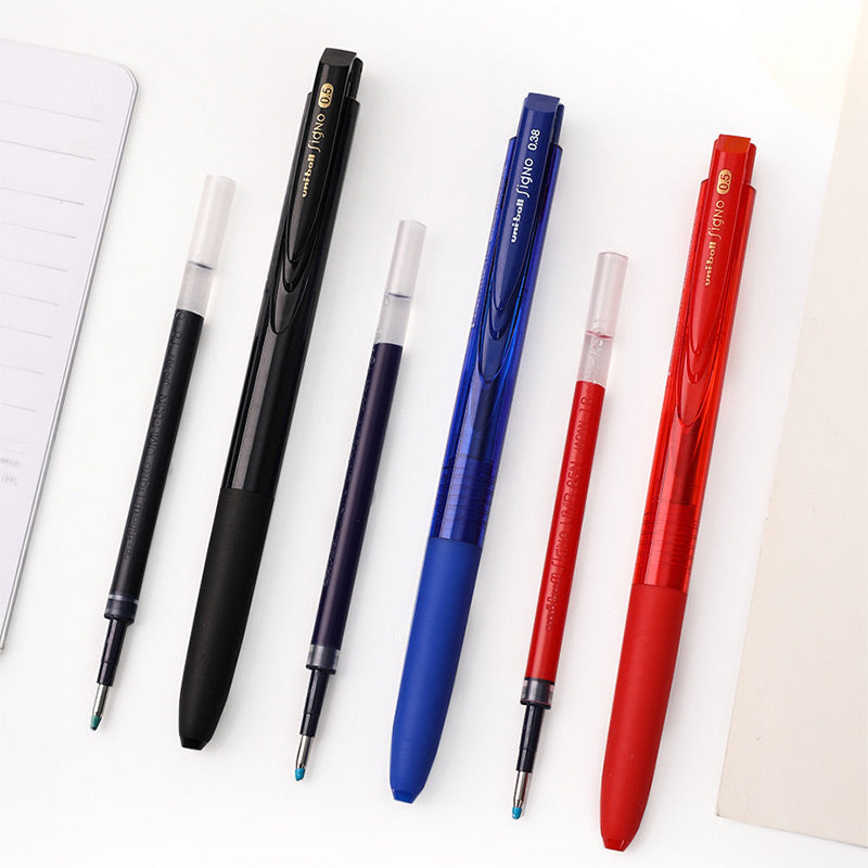 Black, blue and red Signo RT1 pens standing beside matching replacement gel ink refills
