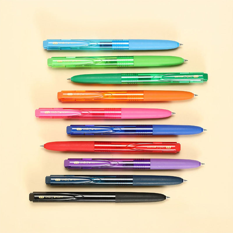 Ten transparent-barrel Signo RT1 gel pens in a row on a cream background beside a notebook and gold clips